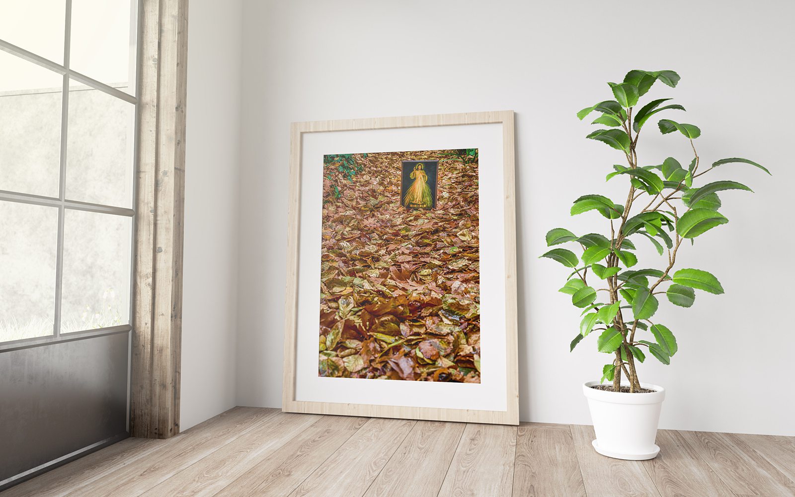 A Divine Mercy icon of the merciful Jesus set among fallen autumn leaves