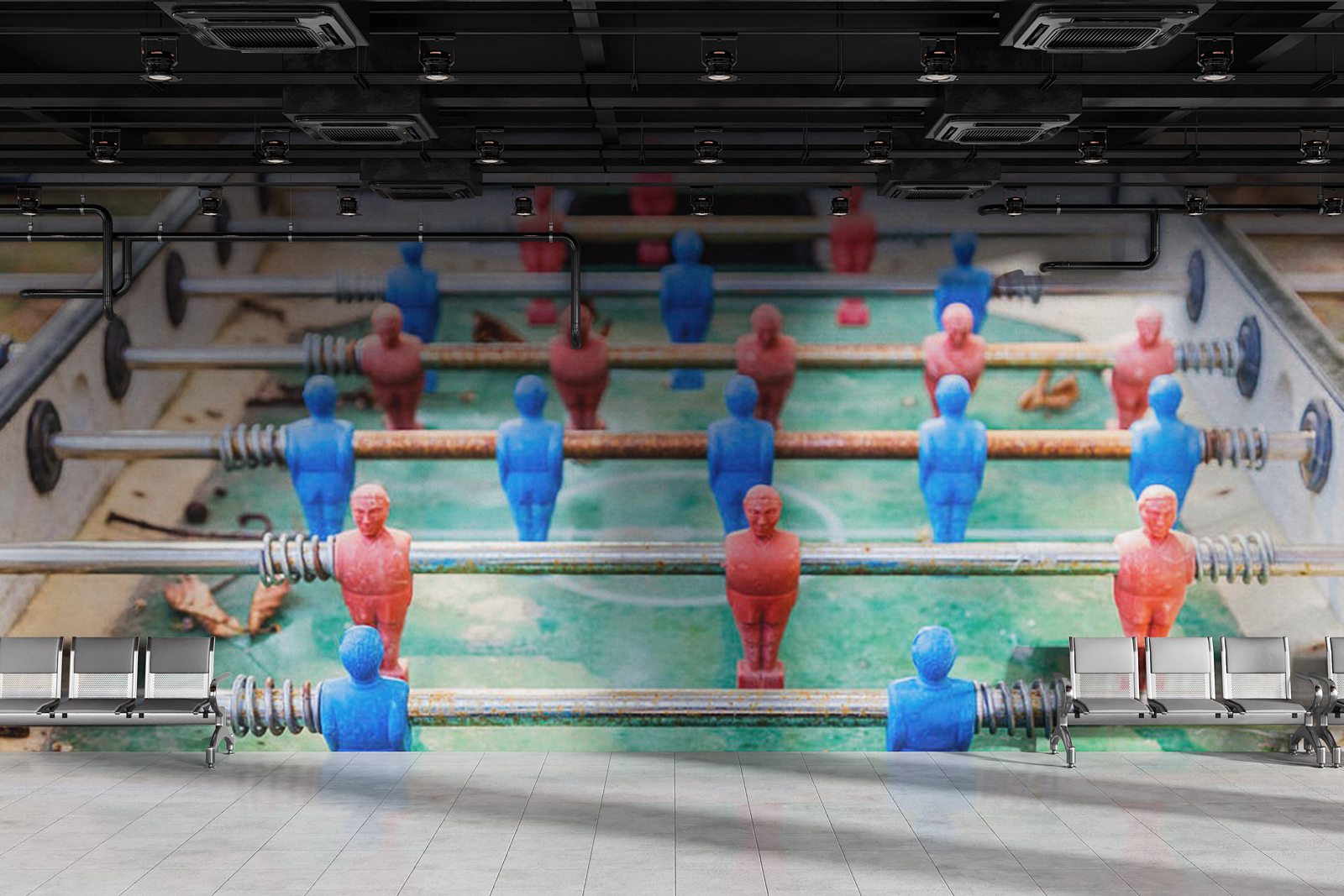 Photograph of a weathered red and blue vintage foosball table